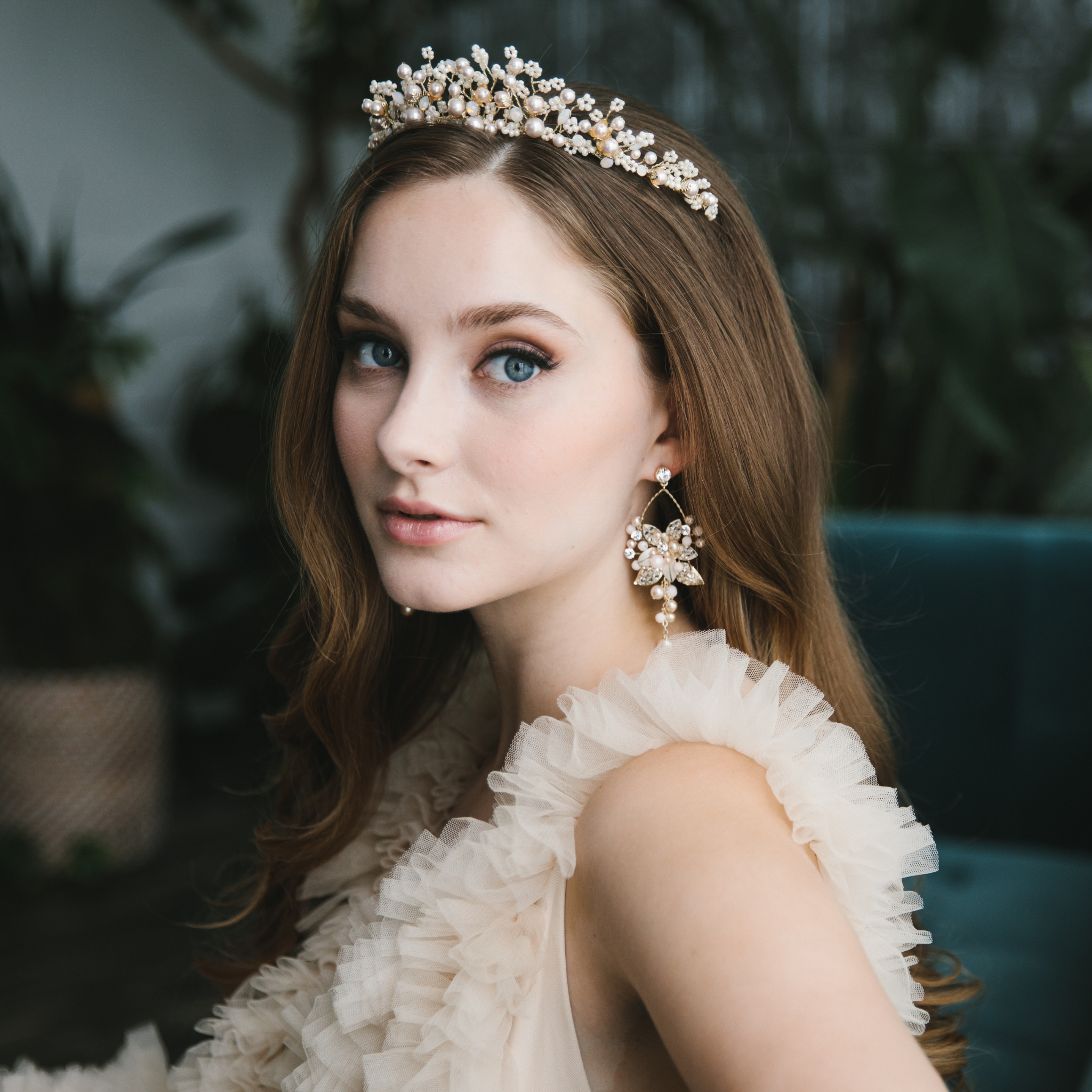 bride wearing crown with pearls and flowers for her wedding day