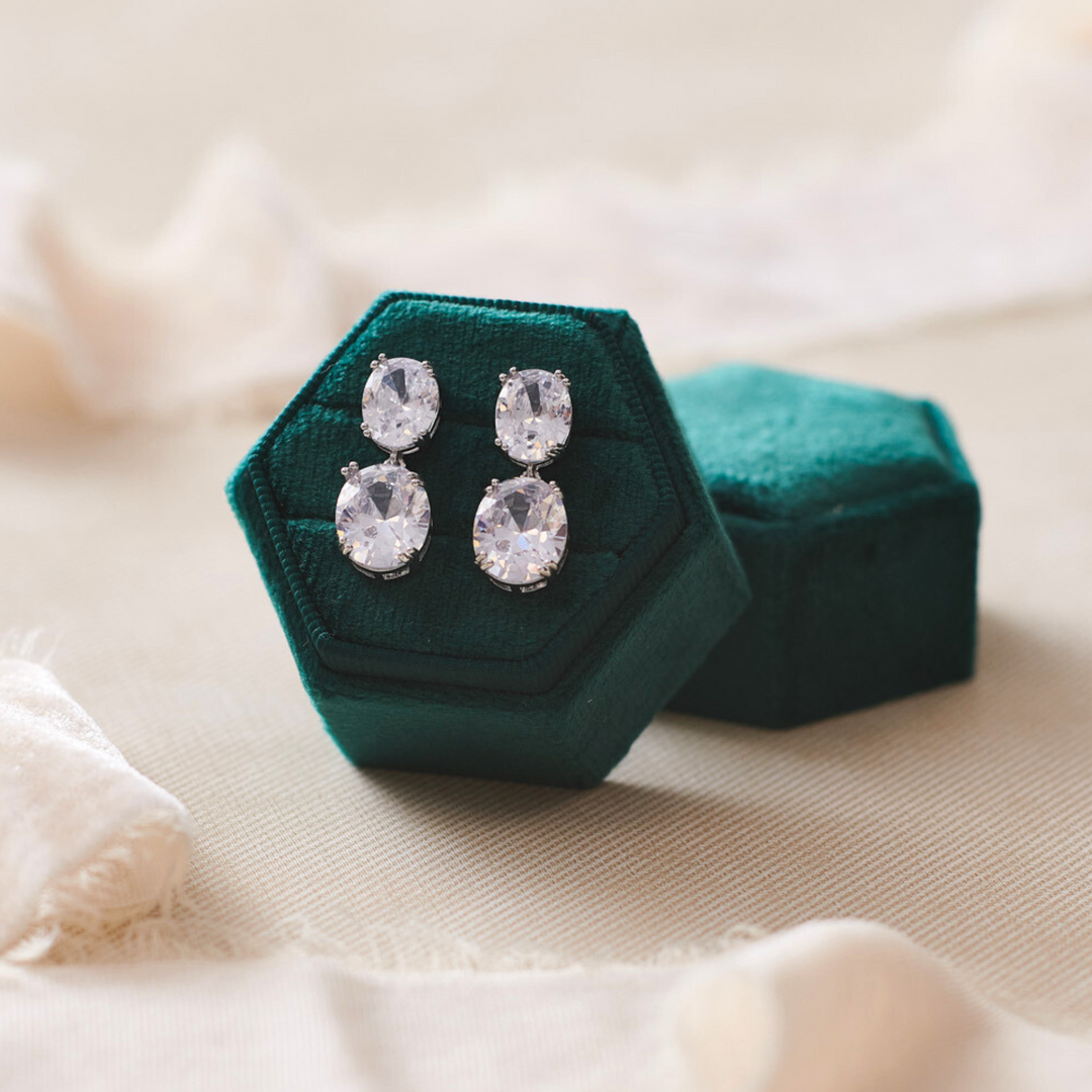CZ wedding earrings in emerald green ring box