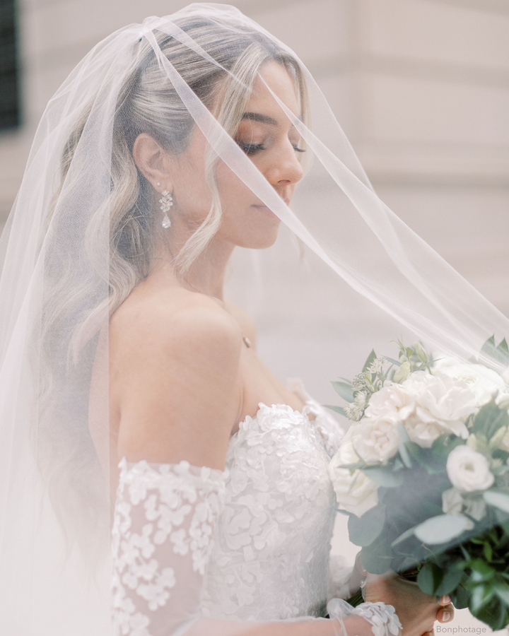 Bride wearing veil and cz dangle earrings on bride