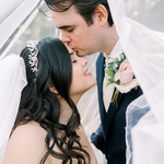 Bride wearing veil and tiara and groom on wedding day
