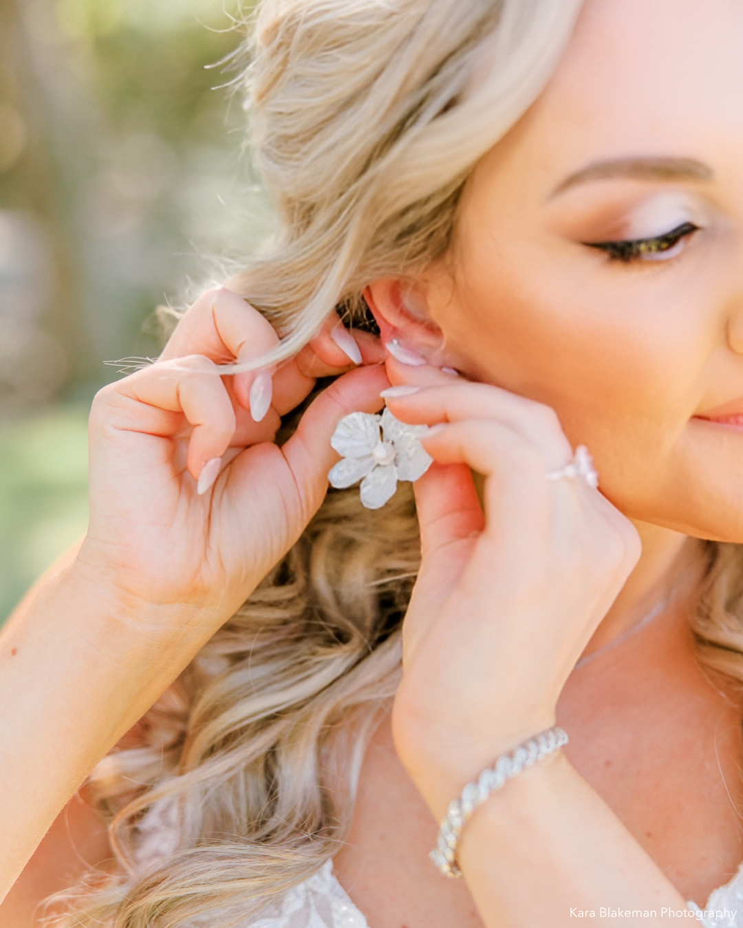 Bridal earrings shaped like flowers on a bride