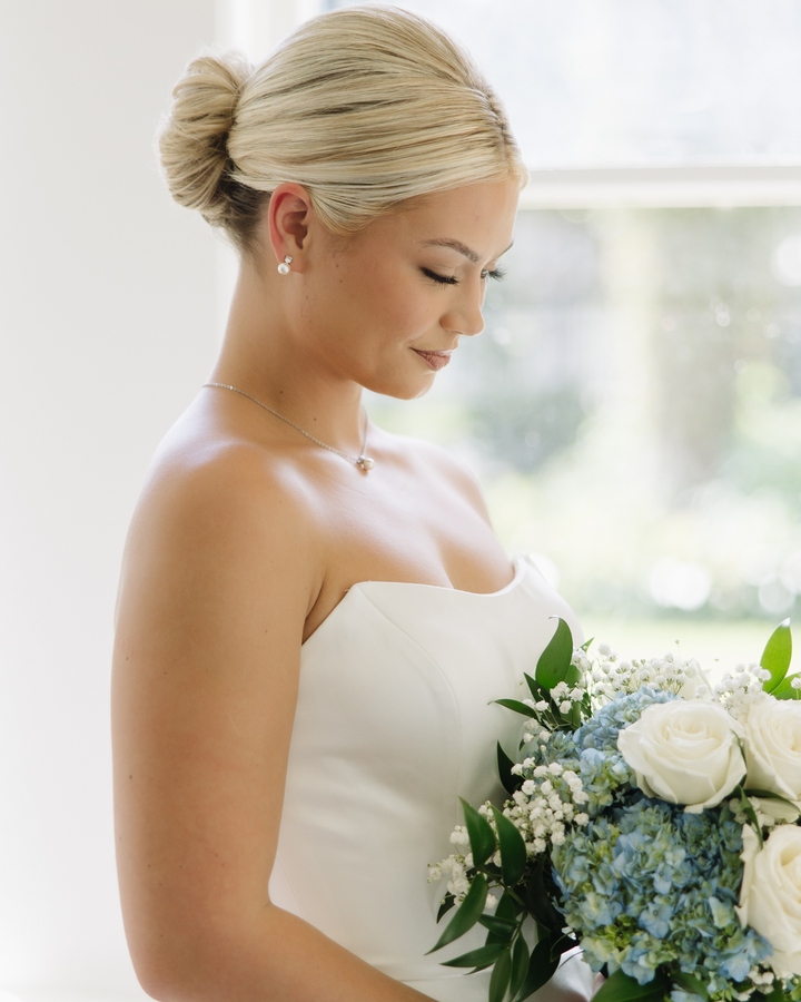 Bride wearing Dareth Colburn jewelry set with pearl studs and CZ accents