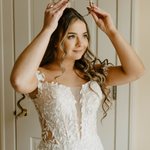 Bride in Wedding Dress Wearing a Tiara with Opals and Rhinestones on her Wedding Day