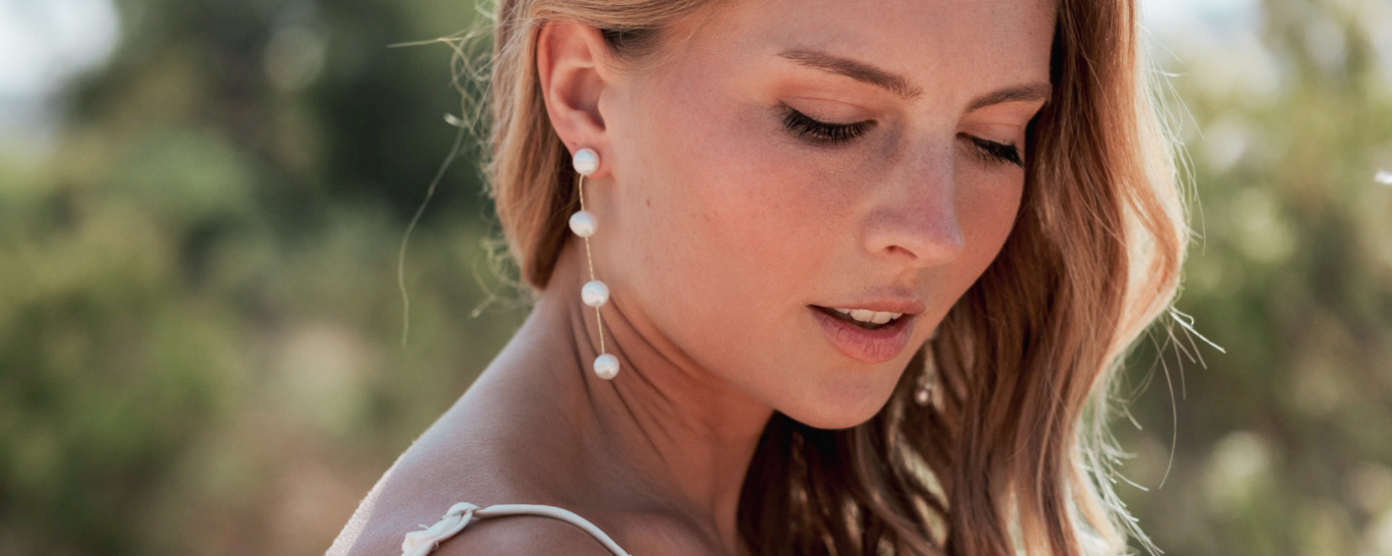Bride wearing pearl dangle Dareth Colburn earings