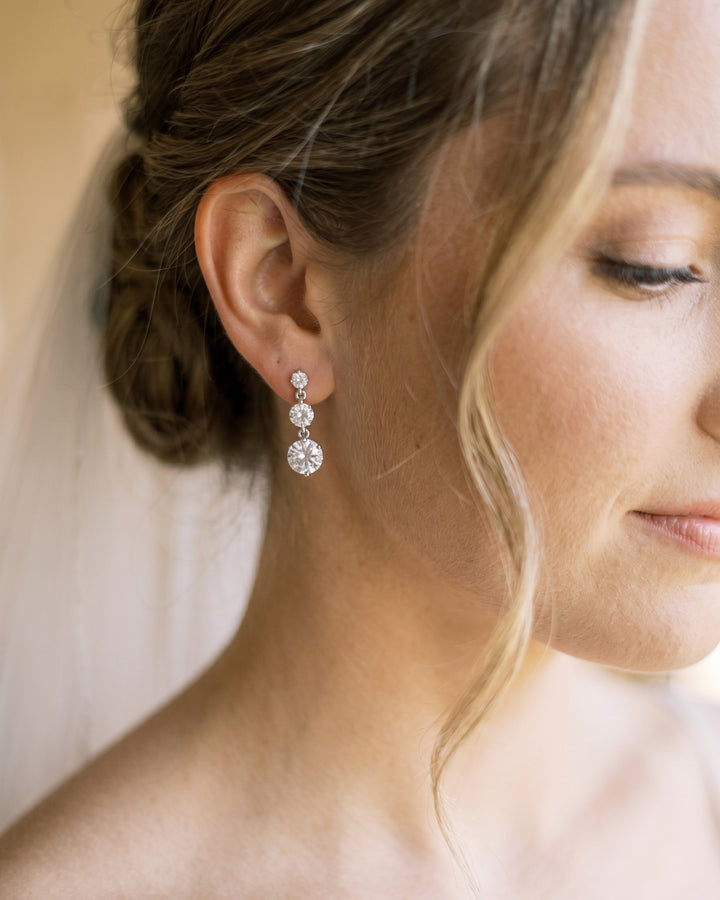 Bride wearing Nadia cubic zirconia drop earrings, close-up side profile