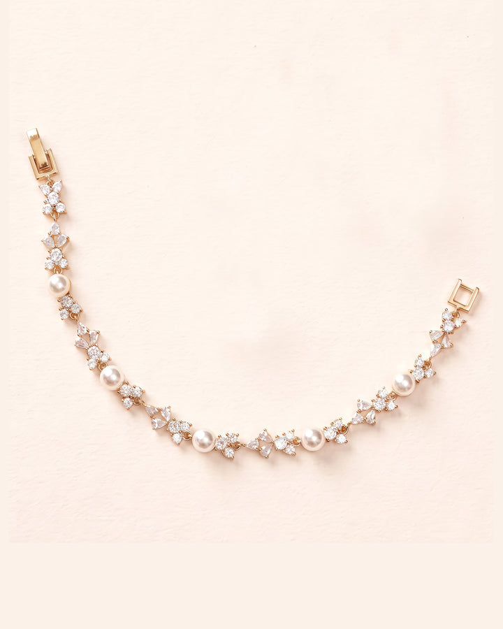 Gold Kelsey bracelet with pearls between clusters of cubic zirconia