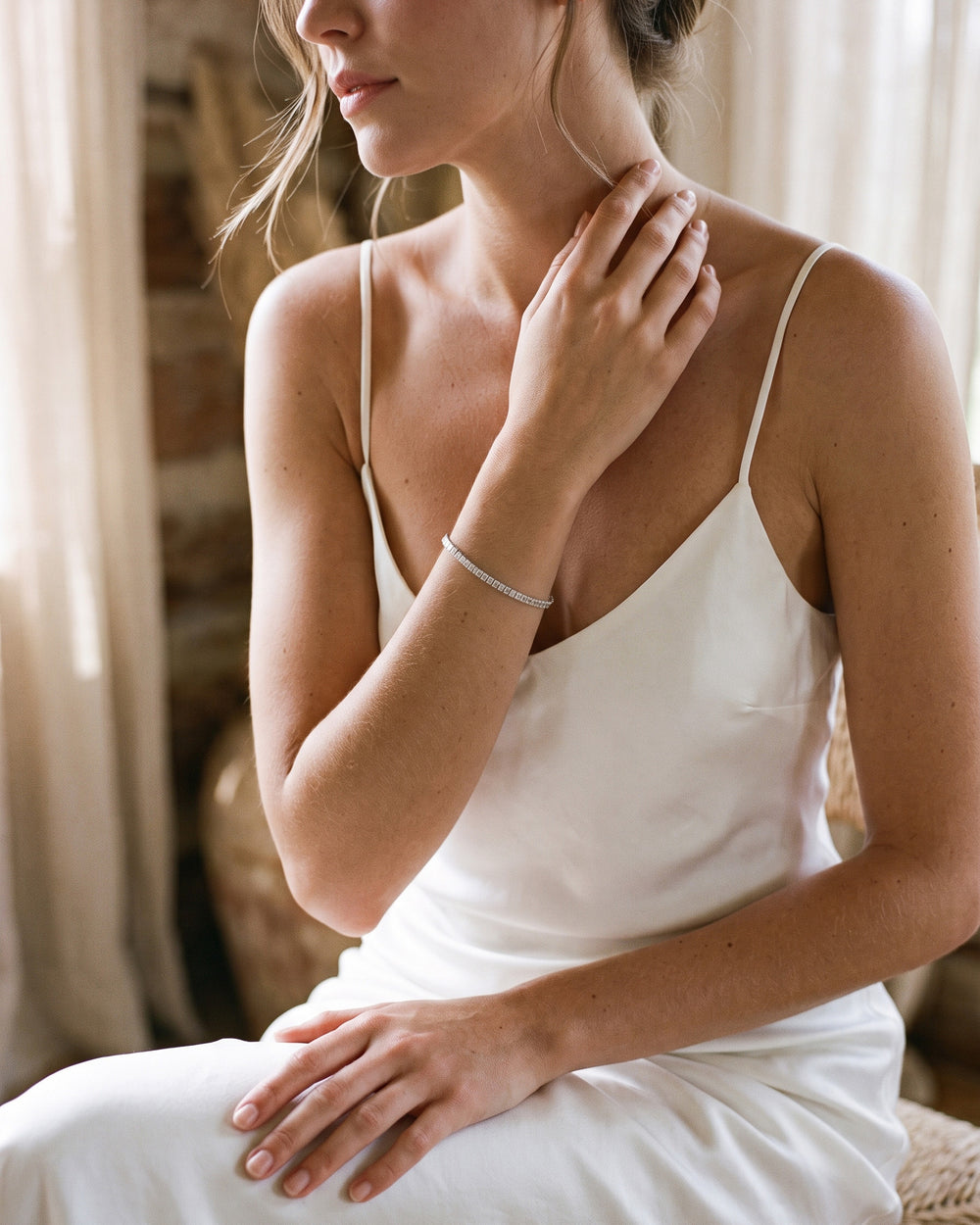 Bride in white wearing the silver Eliza tennis bracelet on her wrist