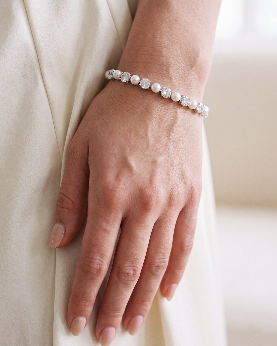 Pearl and CZ tennis bracelet with ivory pearls alternating with round-cut cubic zirconia in silver