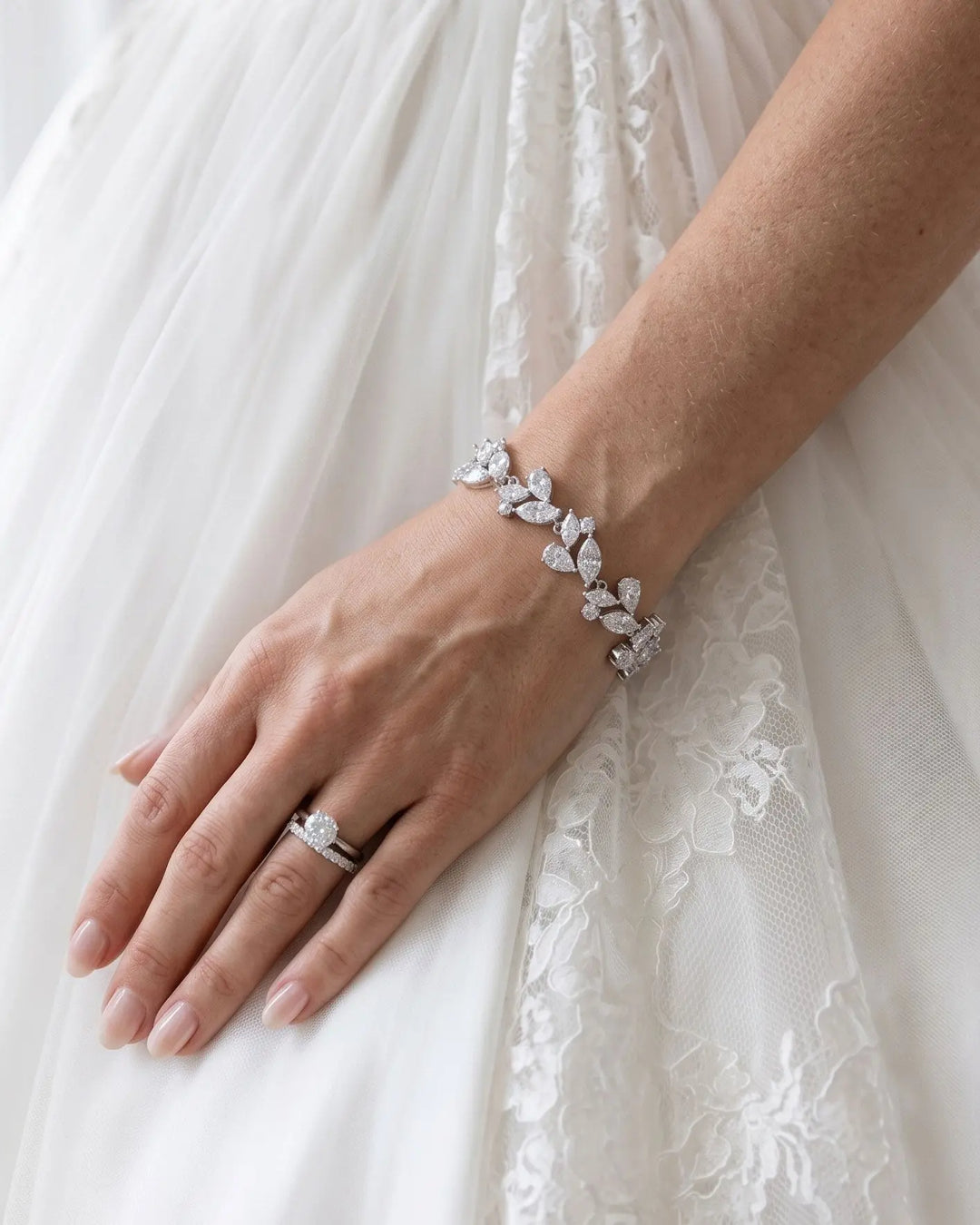 Bride wearing a silver leaf cluster cubic zirconia bracelet on her wrist