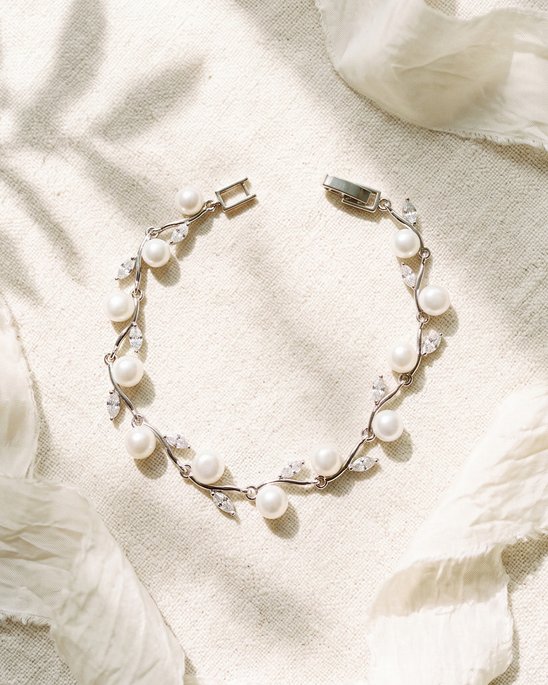 Ciara Pearl Bracelet, a slim silver bridal bracelet with light ivory freshwater pearls and marquise cubic zirconia