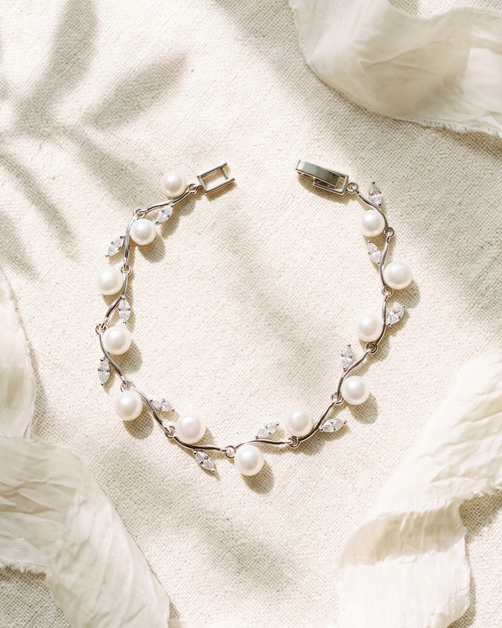 Ciara Pearl Bracelet, a slim silver bridal bracelet with light ivory freshwater pearls and marquise cubic zirconia