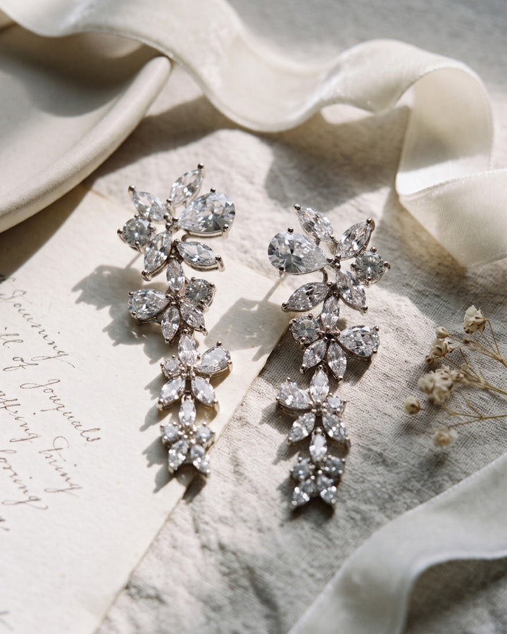 Pair of Delilah earrings showing the sparkling flower clusters of marquise and pear-cut CZ