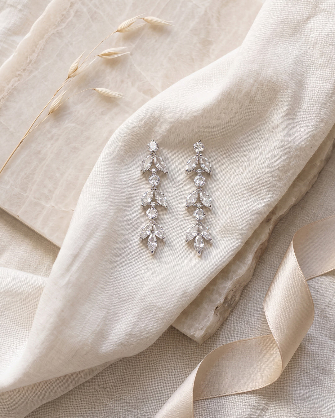Full length of the Sydney earrings showing three stacked clusters of marquise cubic zirconia