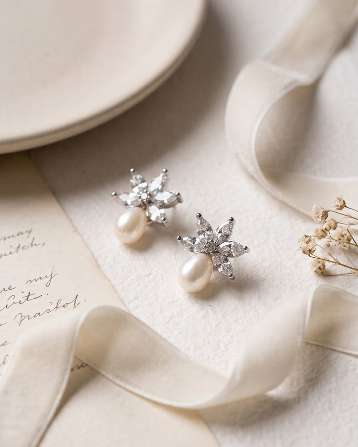 Pair of Naomi earrings showing marquise CZ above luminous freshwater pearls