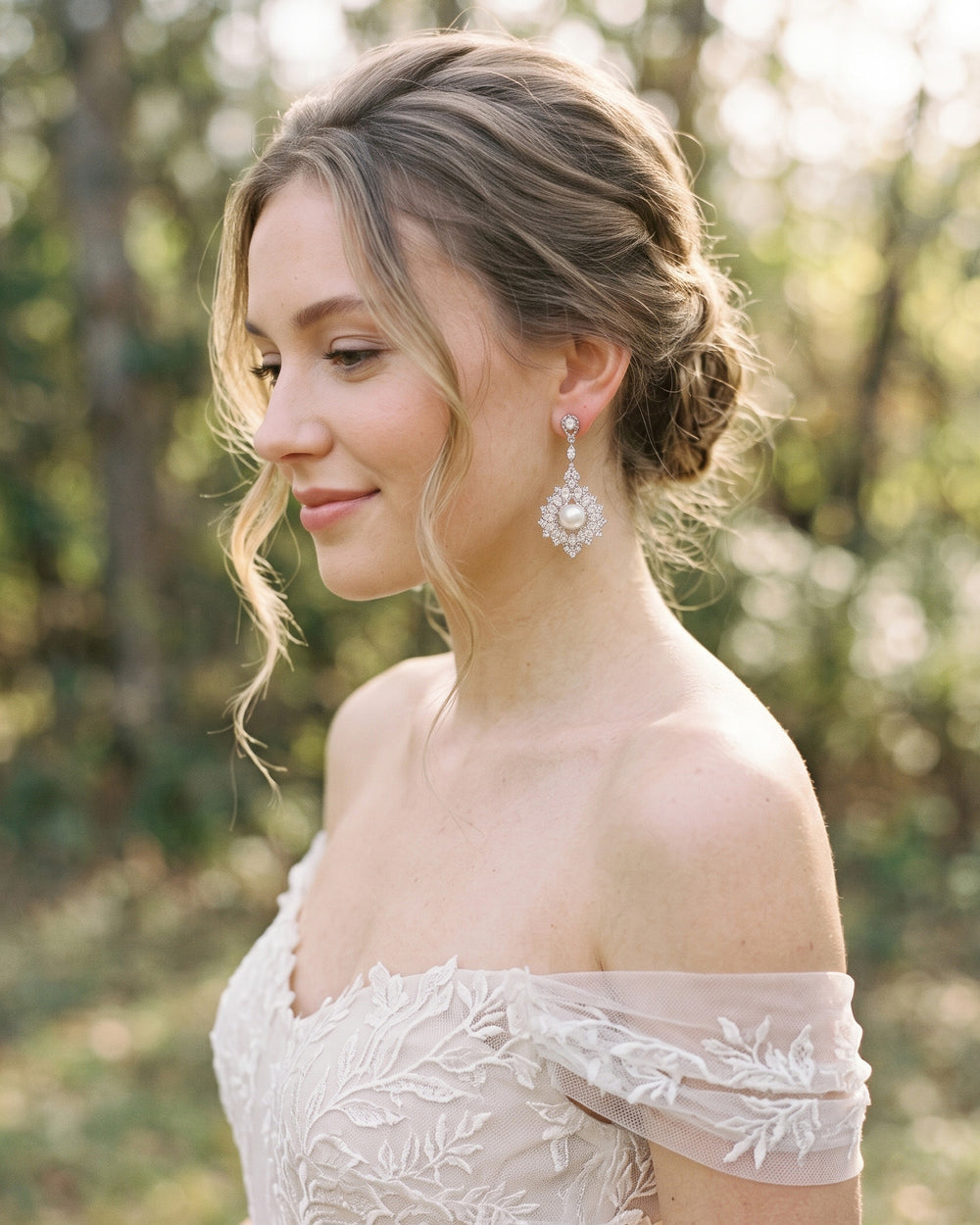 Bride in an off-the-shoulder lace gown wearing the Avery pearl and CZ wedding earrings