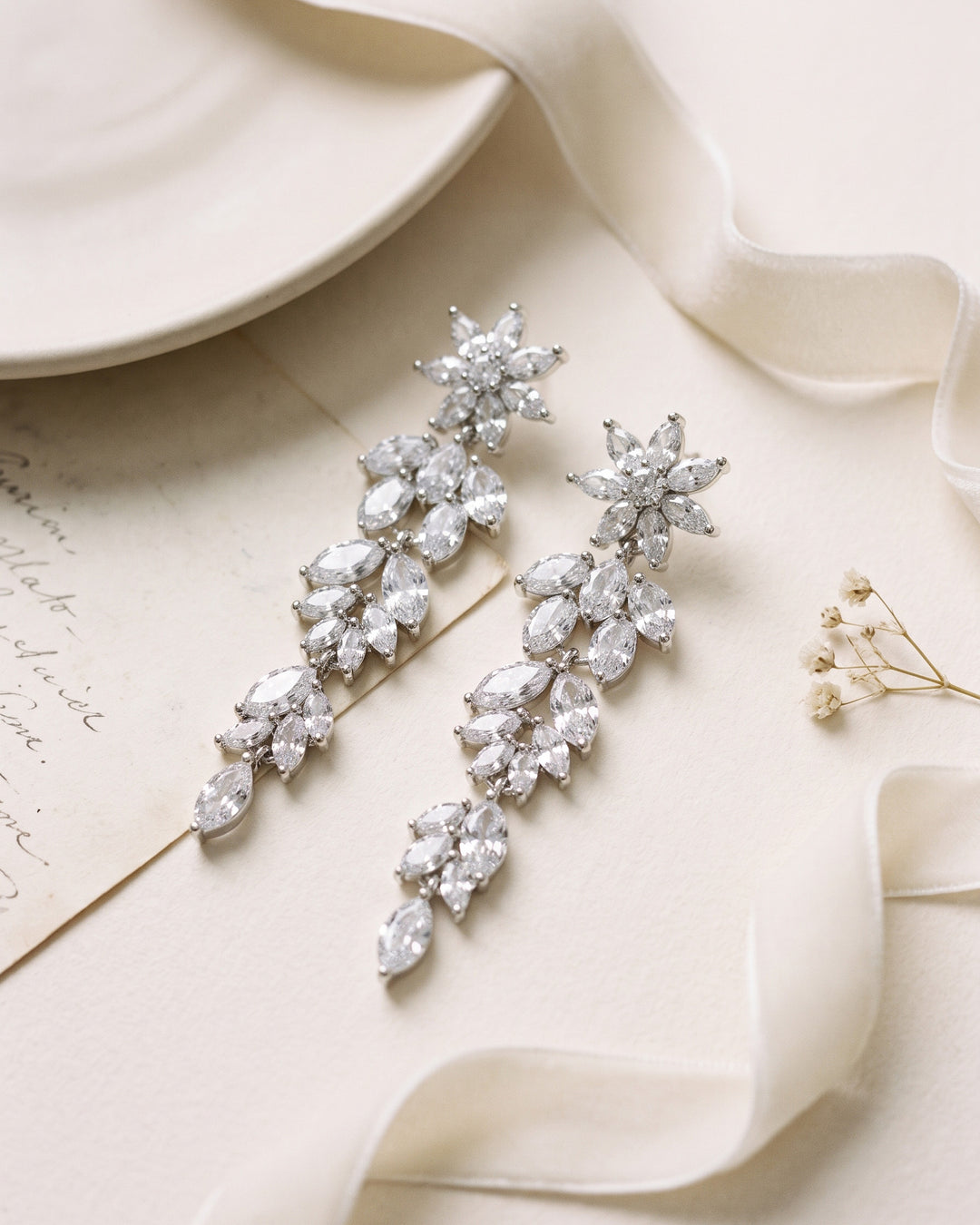 Pair of Chantal earrings laid flat, showing the cascading marquise cubic zirconia