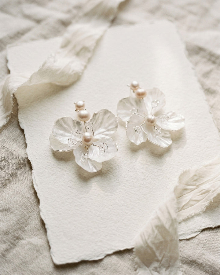 Nia statement flower earrings with pearlescent petals and freshwater pearls on handmade cream paper