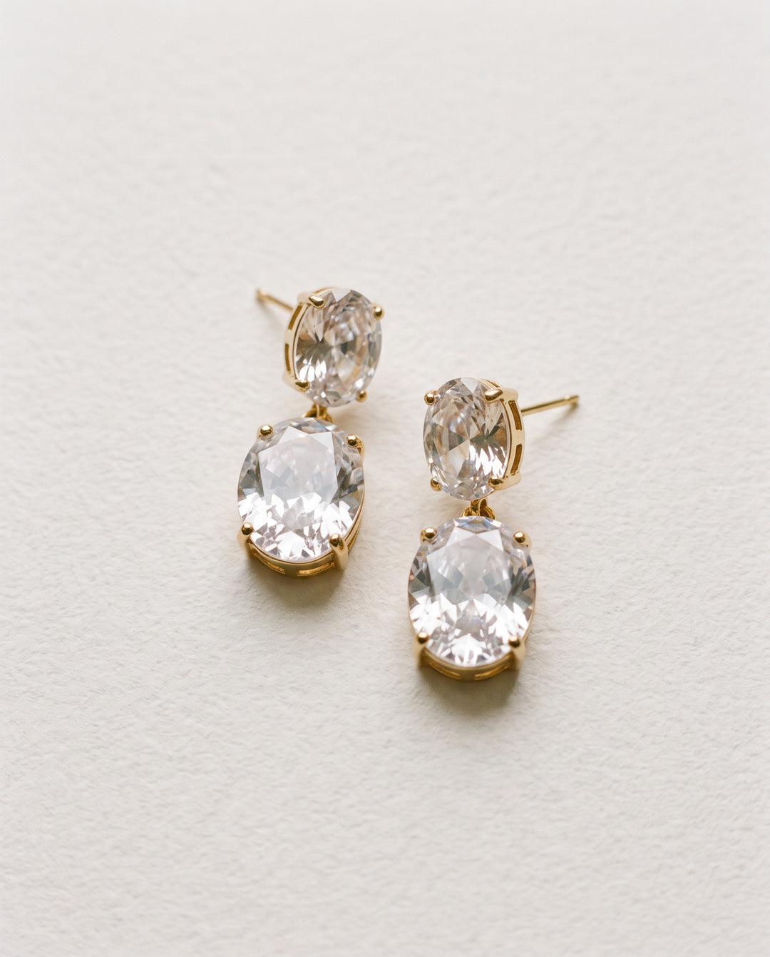 Rosina gold bridal earrings with two oval cubic zirconia stones in a double drop