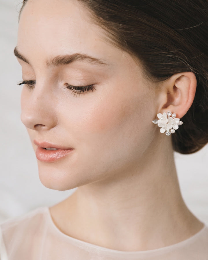 Profile of a bride with a low updo wearing the Elin pearl cluster studs