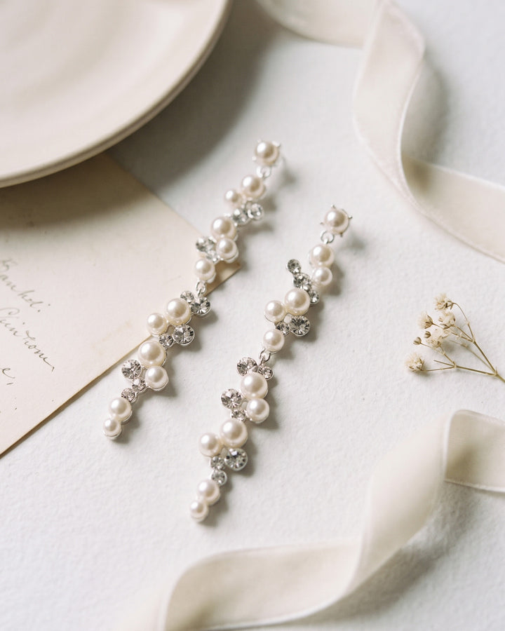 Cassidy wedding earrings styled with ivory ribbon, showing the long cascade of pearls