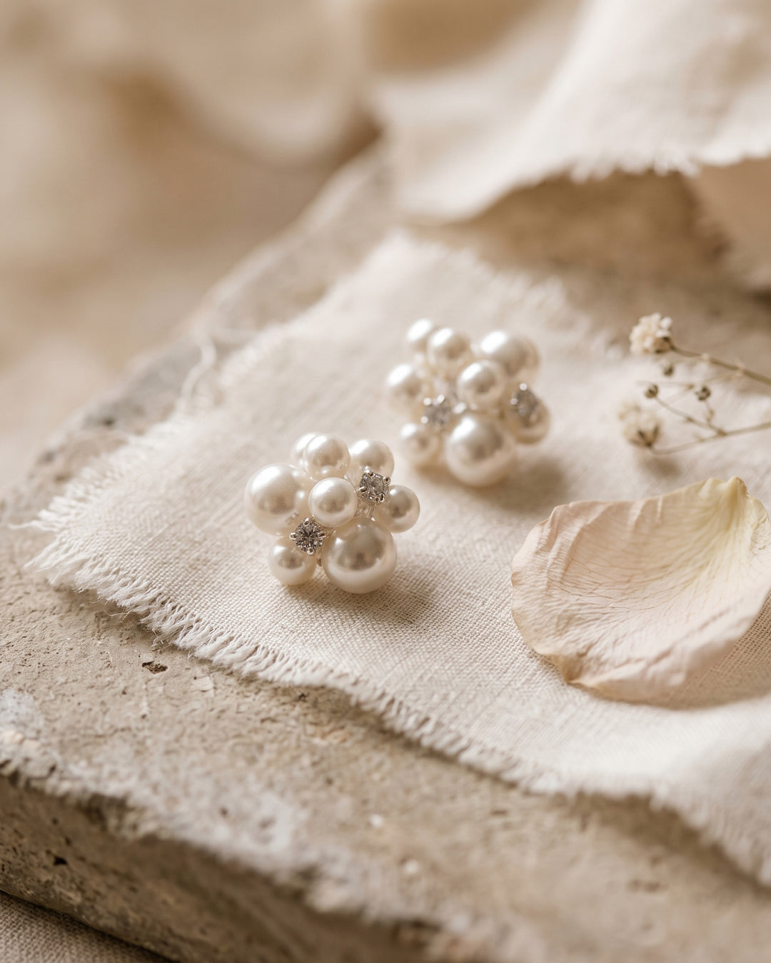 Georgina pearl cluster studs on frayed linen and stone with a soft petal