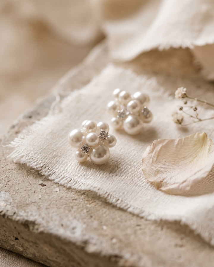 Georgina pearl cluster studs on frayed linen and stone with a soft petal