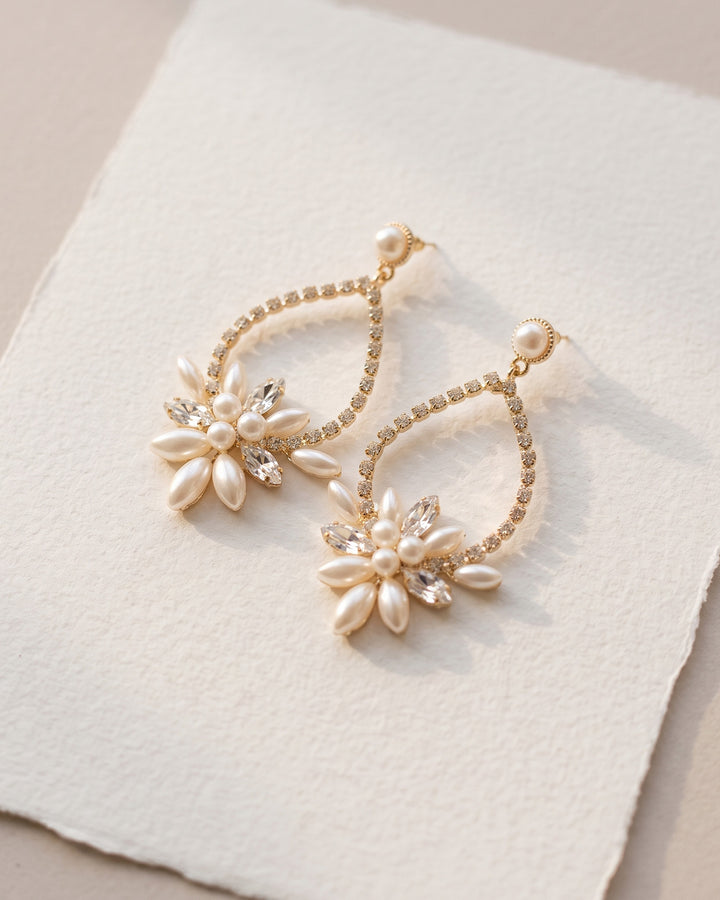 Gold Marnie wedding earrings with pearl flowers on handmade ivory paper