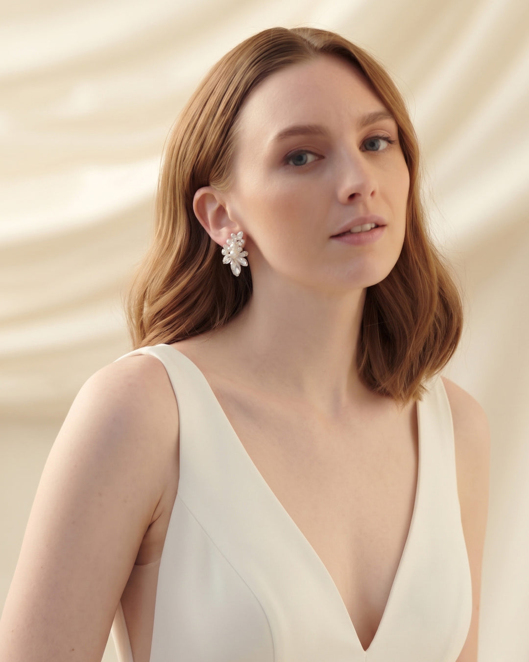 Model in a V-neck gown wearing the Gwyneth statement earrings