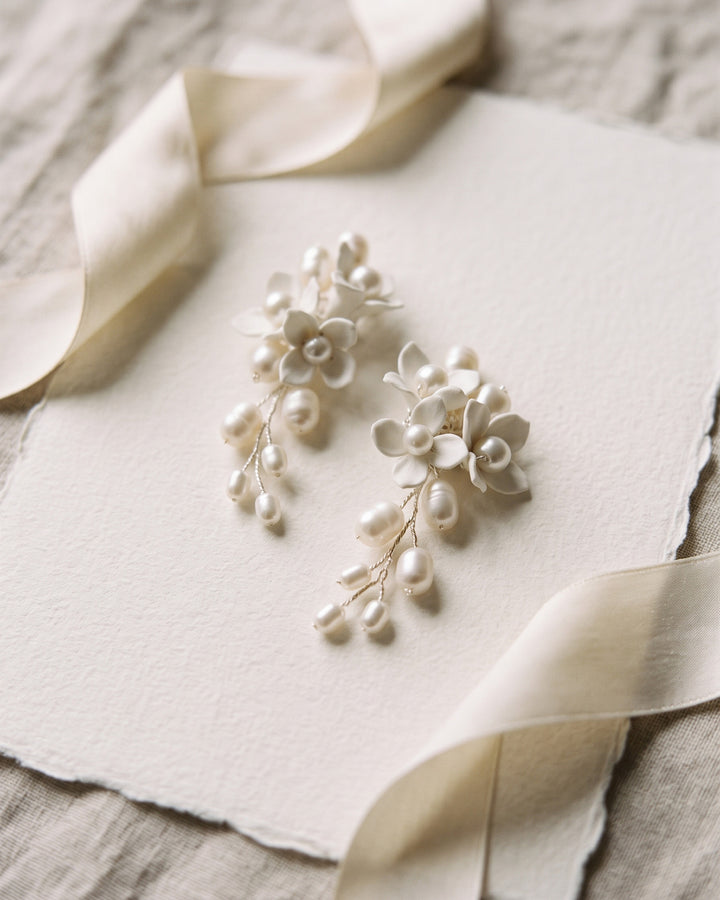 Taylor bridal earrings with asymmetrical ivory flowers and freshwater pearls on cream paper with ribbon