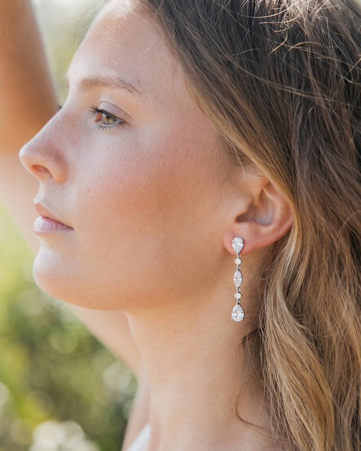 Profile of a bride with soft waves wearing the Gracie CZ drop earrings outdoors