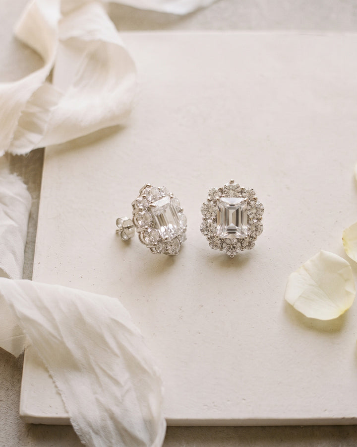 Sienna wedding studs on a cream board with silk ribbon and a single petal