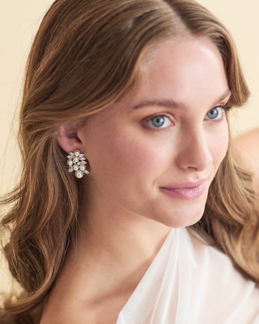 Annalise earrings with simulated diamonds and pearls in a clustered design, plated in 18k gold or rhodium