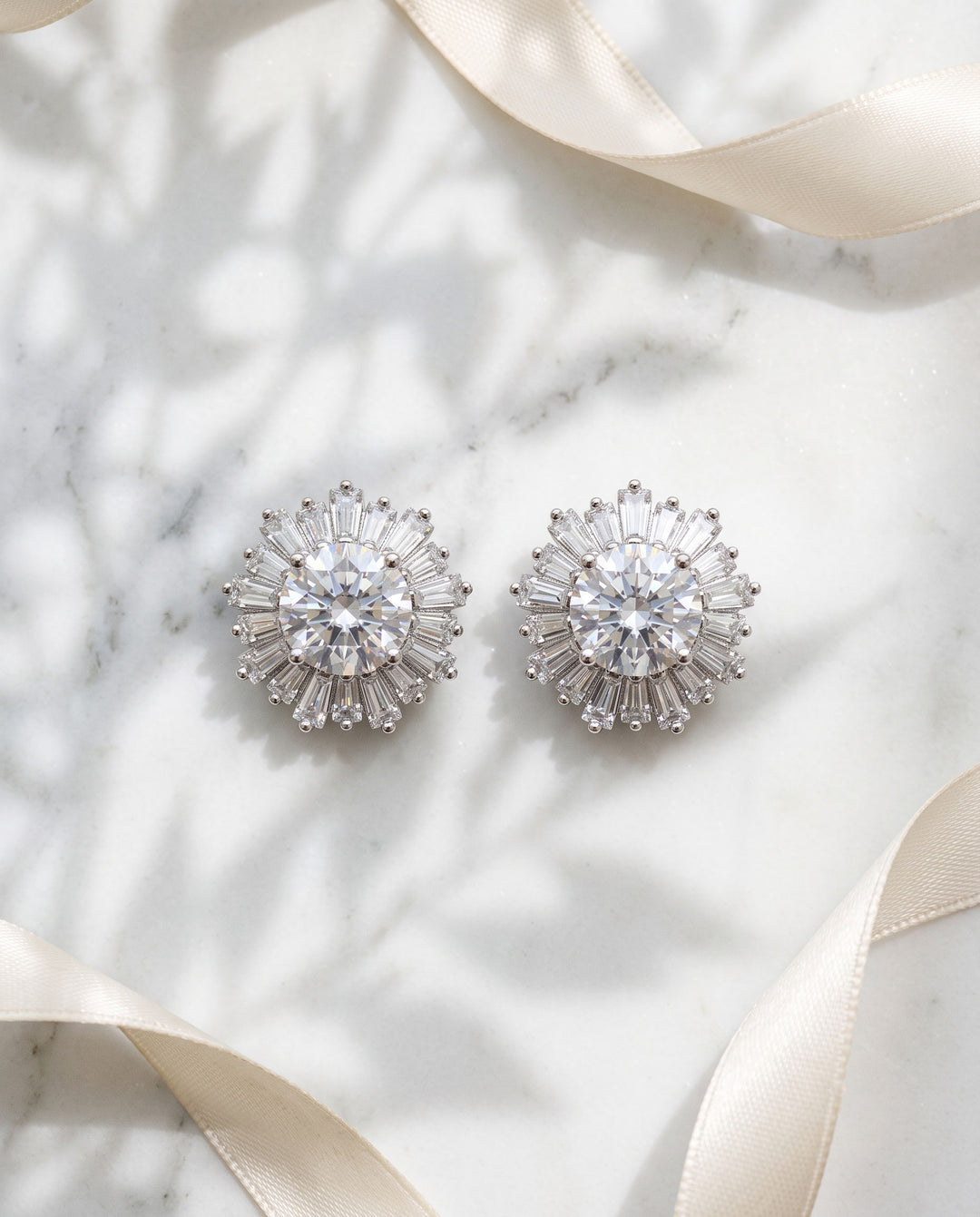 Close-up of Shivani CZ stud earrings showing the baguette halo and 0.5 inch silver setting