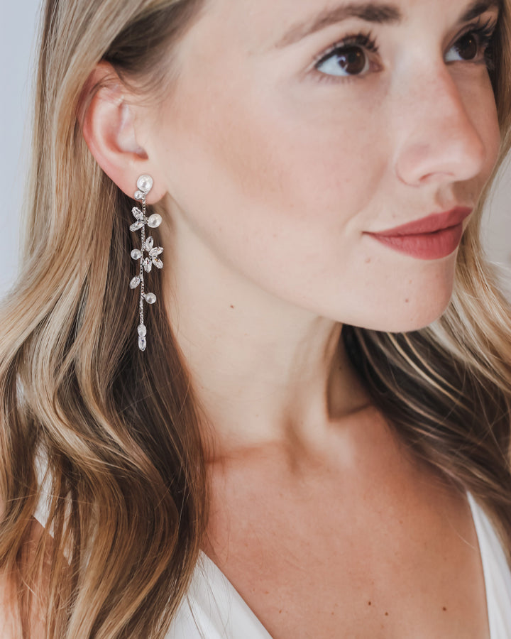 Bride wearing Katrina pearl and cubic zirconia drop earrings with long, loose waves and a V-neck
