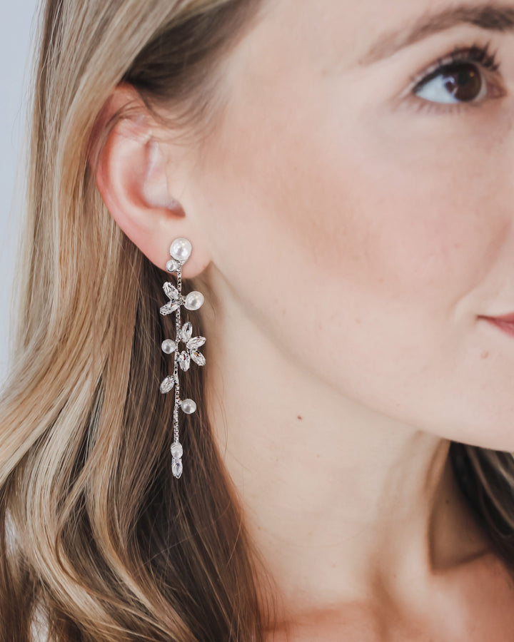 Close-up of a Katrina wedding earring on the ear, showing the pearl stud top and long cascade