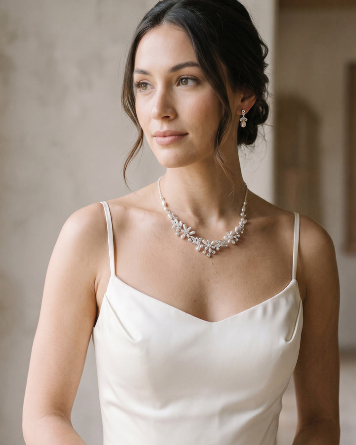 Bride in a satin slip dress wearing the Delicate Pearl wedding necklace and earrings