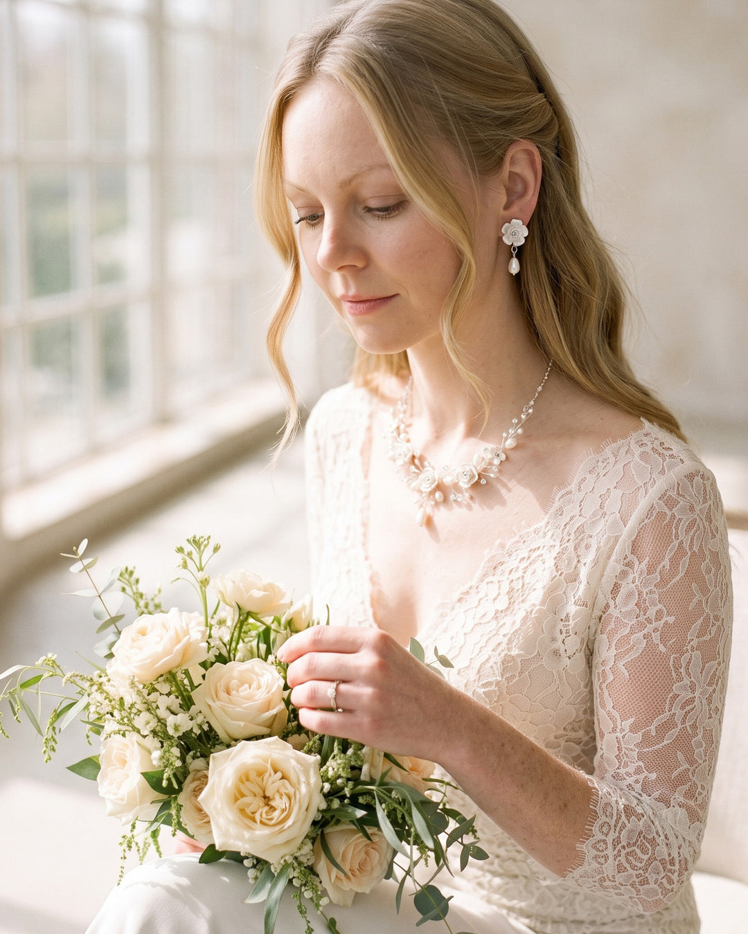 Bride holding a garden rose bouquet wearing the Rose Flower necklace and earrings