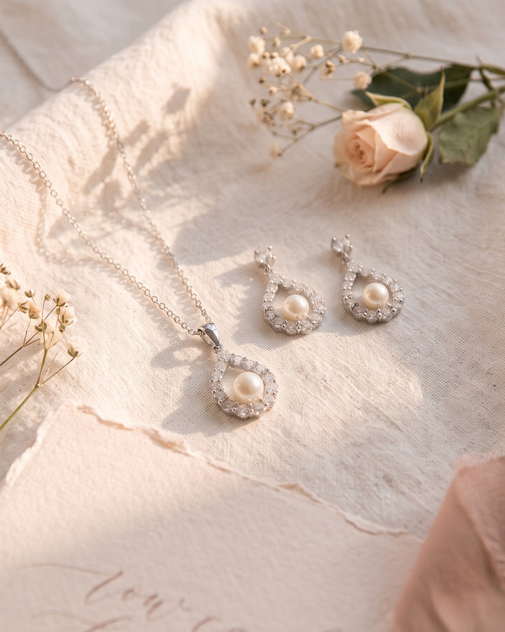 Silver Elegance necklace and earrings on ivory linen with a blush rose and baby's breath