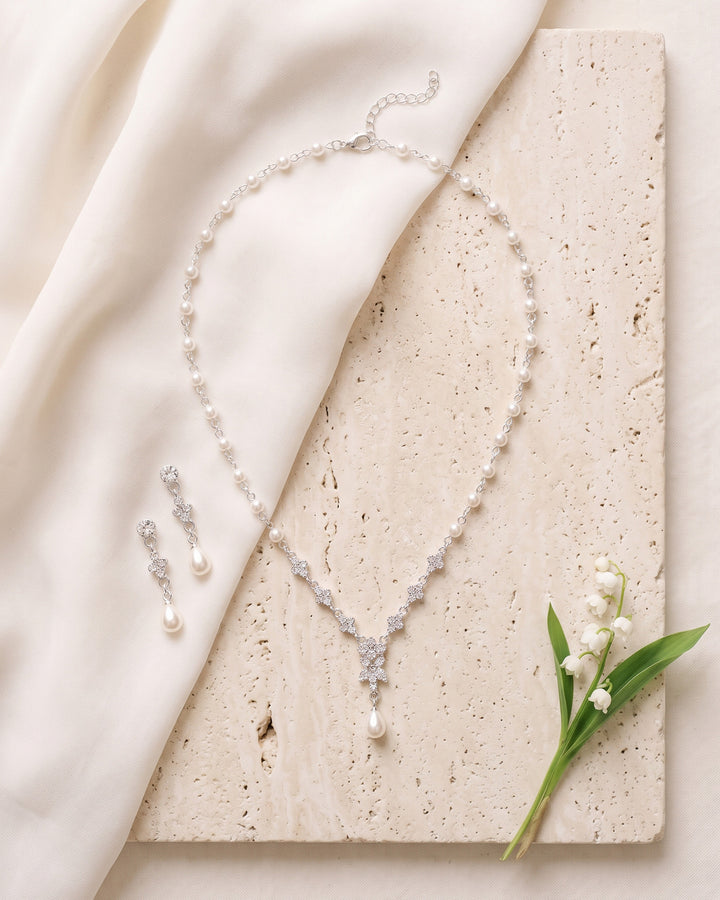Primrose necklace and earrings on travertine and ivory silk with lily of the valley