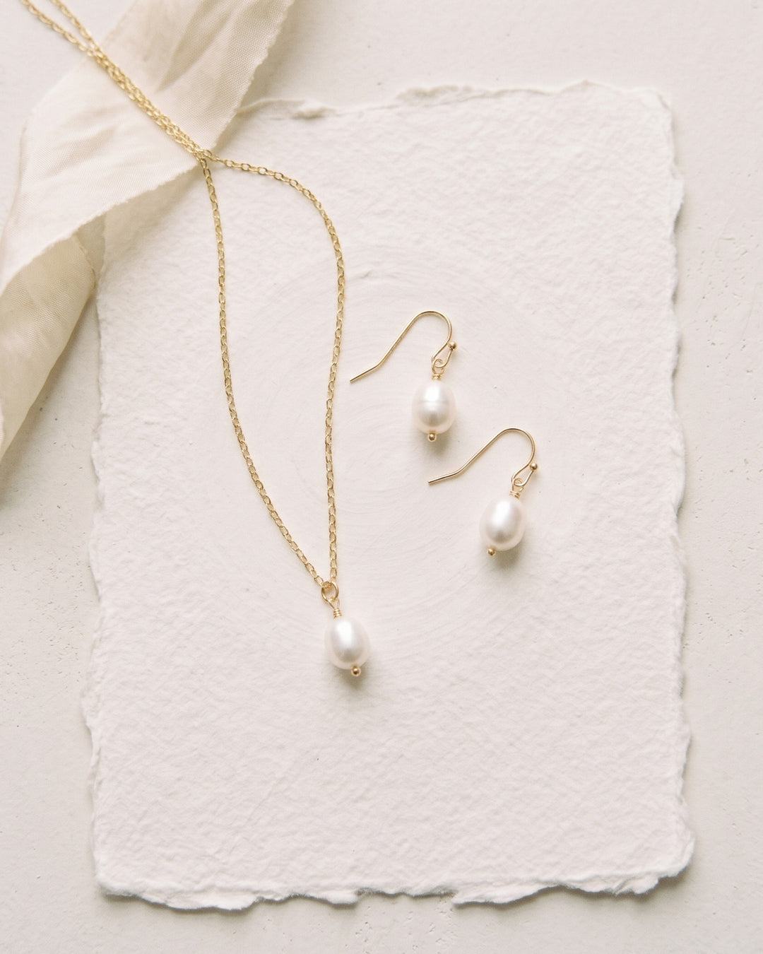 Simple Pearl pendant necklace and earrings on handmade paper with ivory ribbon