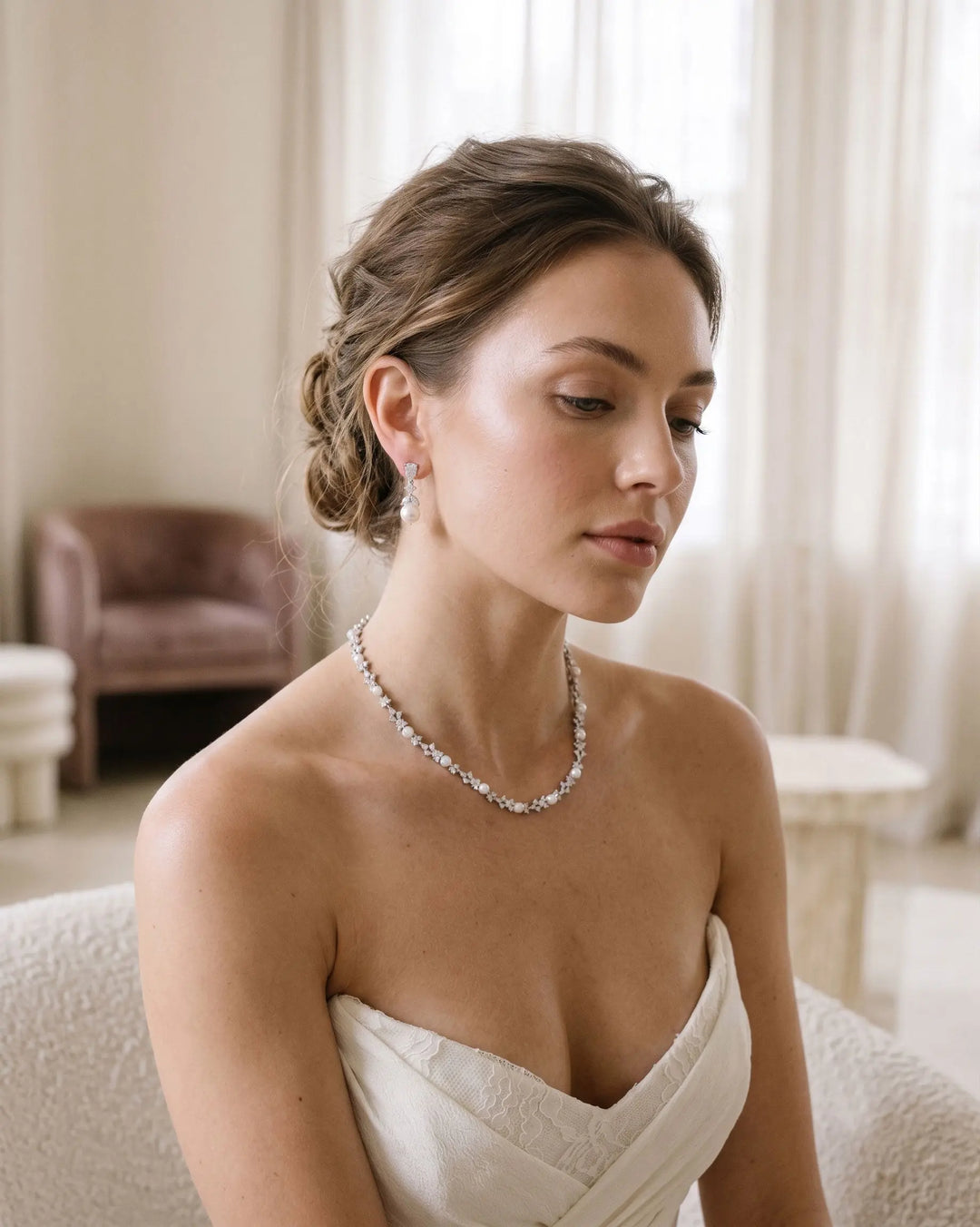 Bride wearing pearl jewelry necklace and earrings