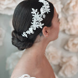 Bride wearing flower hair piece with flowers, pearls and rhinestones