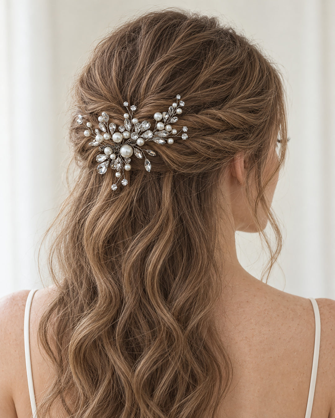 Bride with a half-up style wearing a silver pearl and rhinestone spray clip