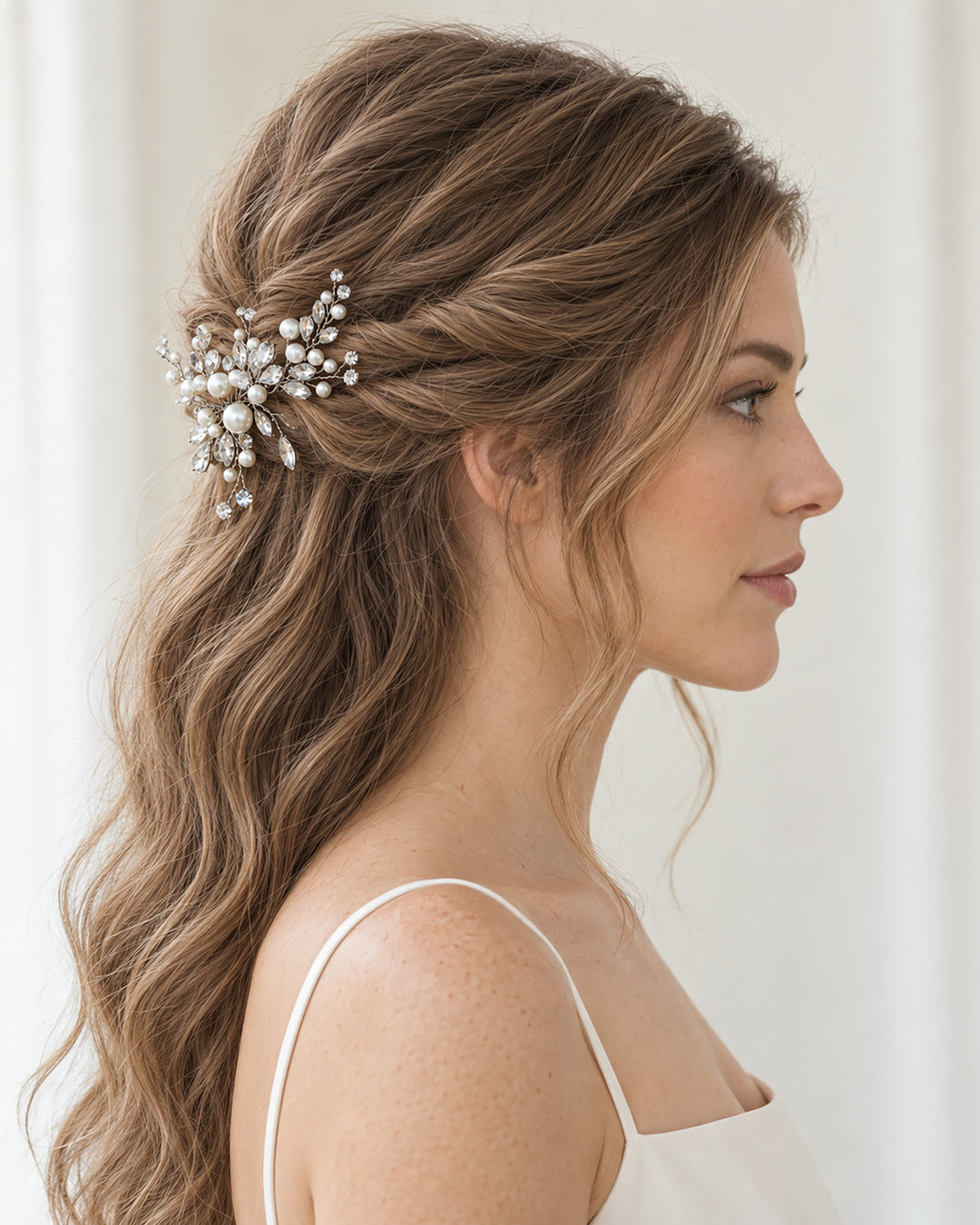 Side profile of a bride with waves wearing a silver bridal hair clip