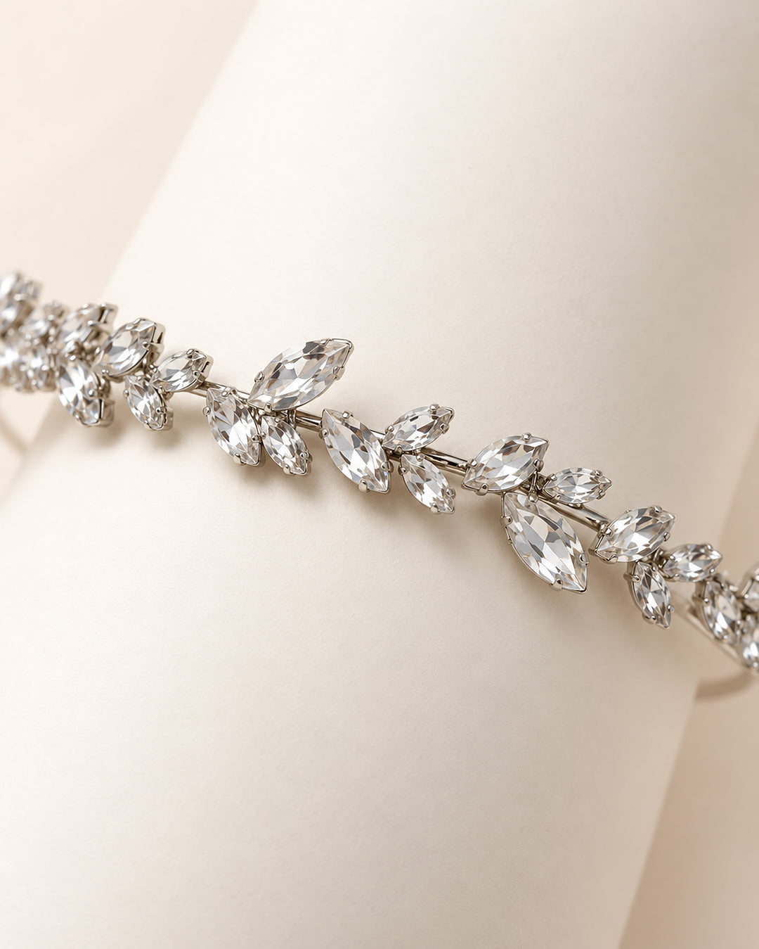 Close-up of marquise rhinestone leaves along the Priya wedding headband vine