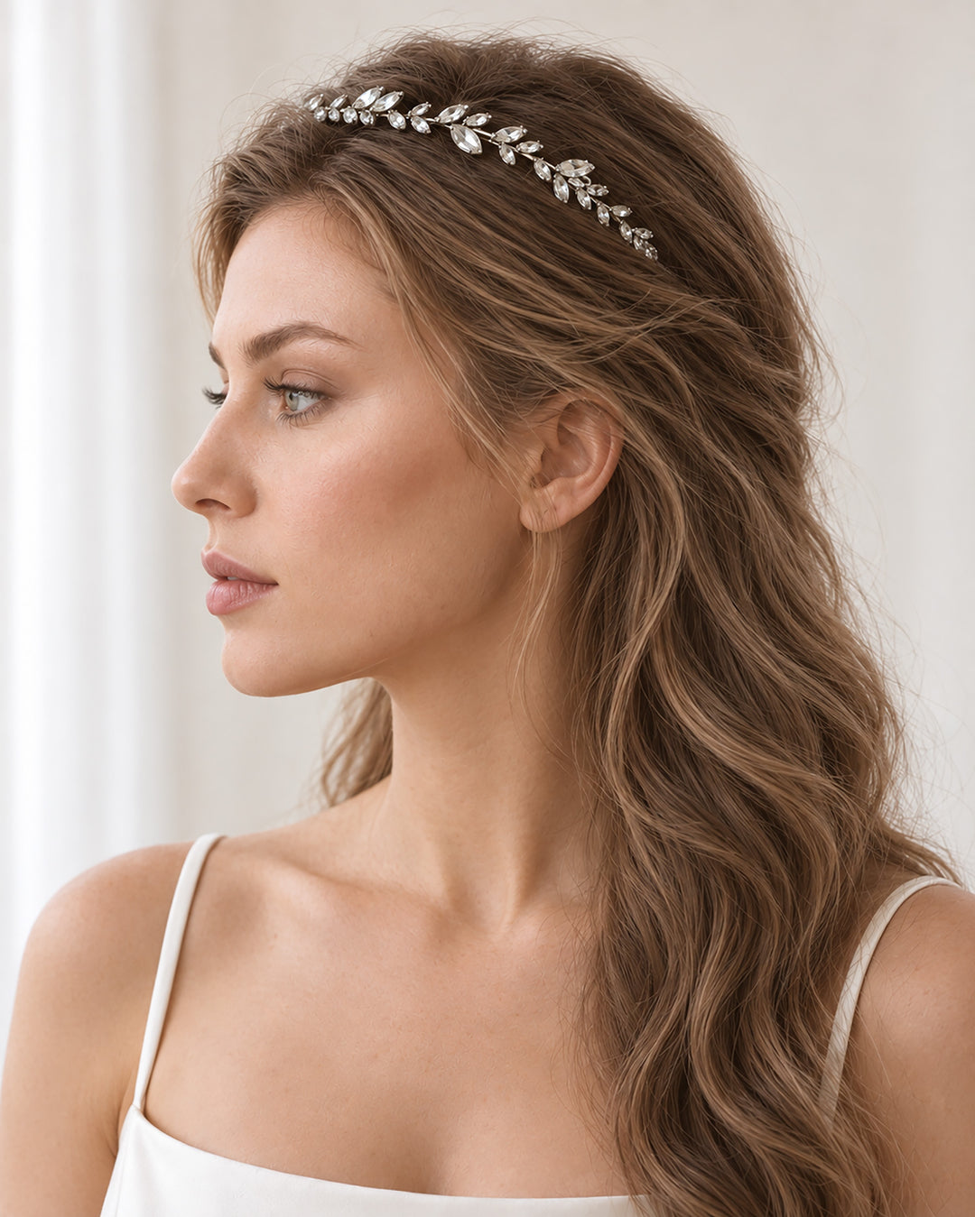 Side profile of a bride wearing the Priya headband with long, soft waves