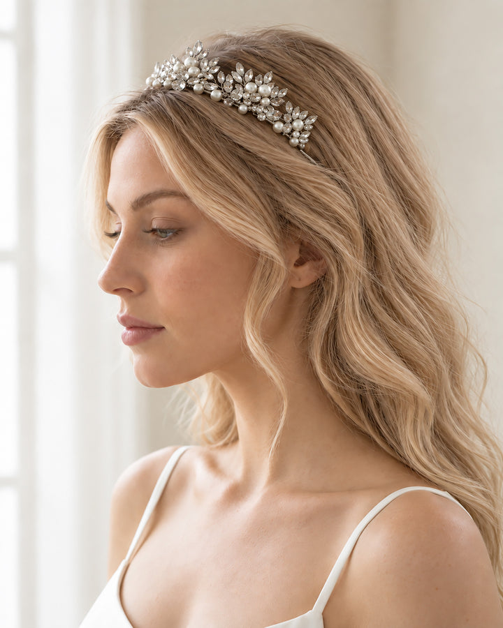Side profile of a bride wearing the Amalie tiara across her crown with long, soft waves
