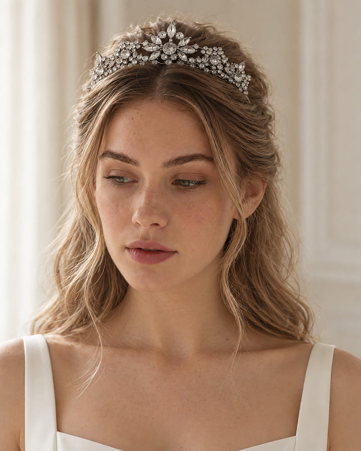 Bride with soft waves wearing a silver rhinestone floral tiara across her crown