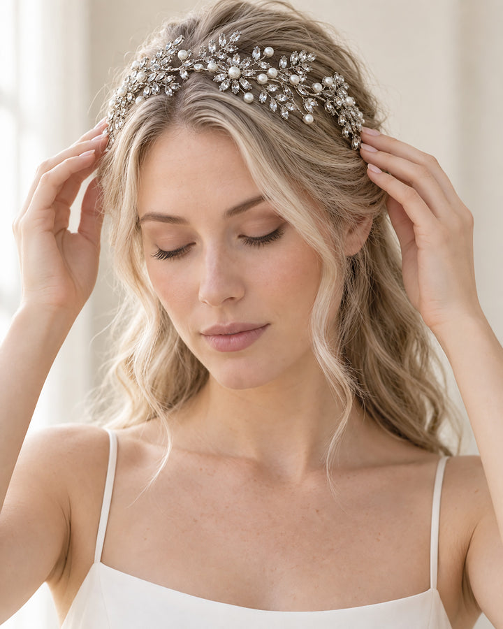 Bride placing the Liora bridal headband across her crown to show how it sits with half-up hair