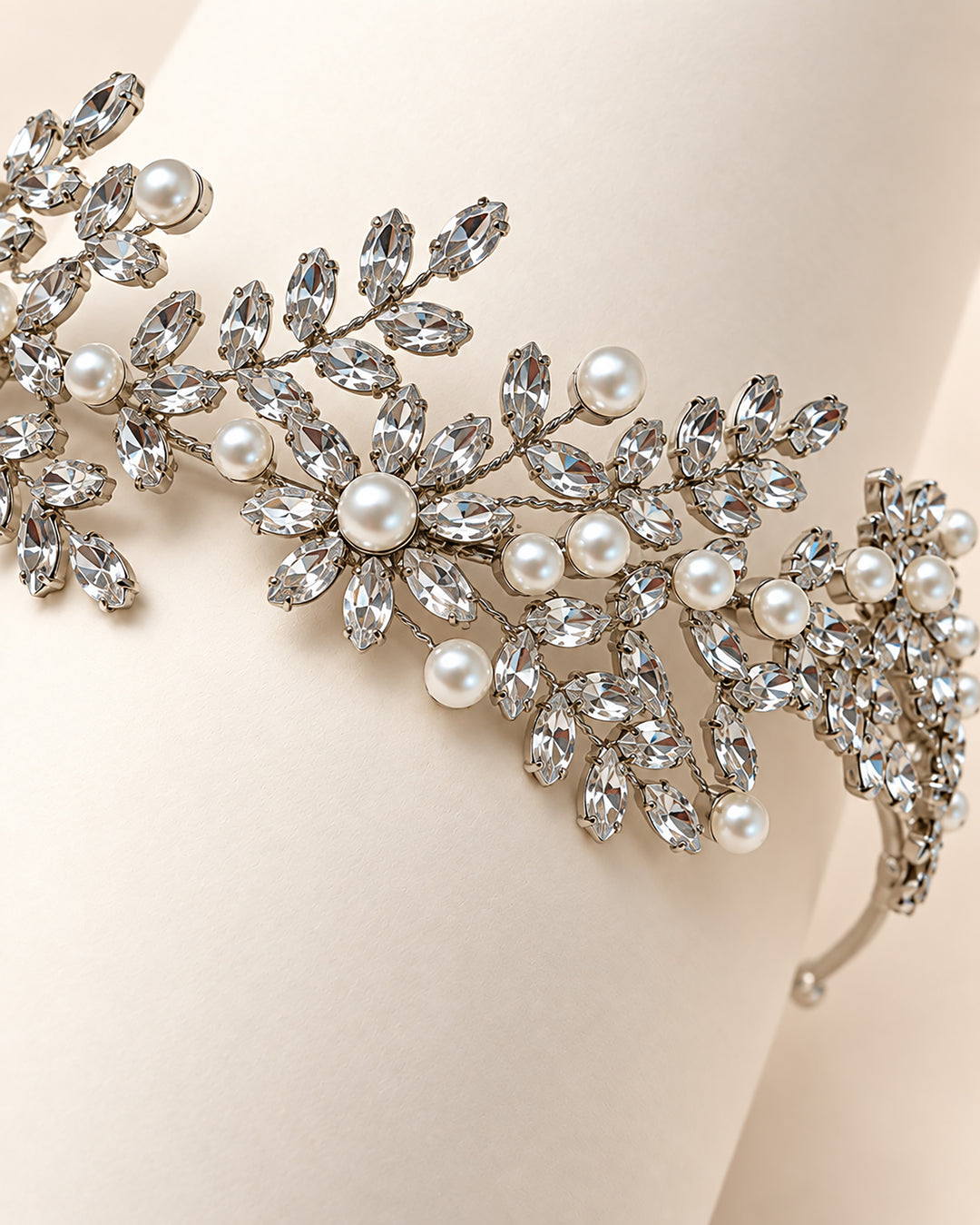 Close-up of marquise rhinestone leaves and ivory pearls on the Liora floral wedding headband